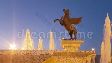 科林斯，希腊，2017年10月5日。 在希腊的科林斯，帕伽索斯雕像在喷泉旁边的夜晚。 美丽的风景